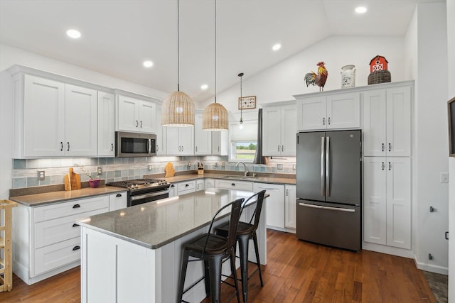10 Windswept Ln, Hillsdale, MI 49242 - kitchen with appliances with stainless steel finishes, a sink, tasteful backsplash, lofted ceiling, and white cabinets