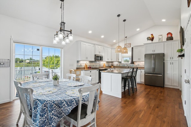 10 Windswept Ln, Hillsdale, MI 49242 - dining area featuring healthy amount of natural light, dark wood-style flooring, vaulted ceiling, and recessed lighting