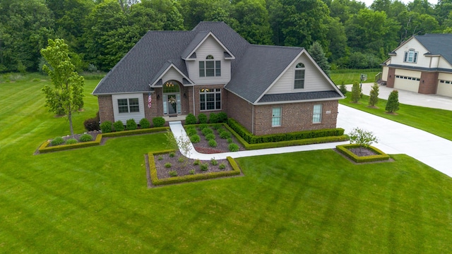133 E Auburn Trl, Brighton, MI 48114 - view of front of home featuring brick siding, a front yard, and driveway