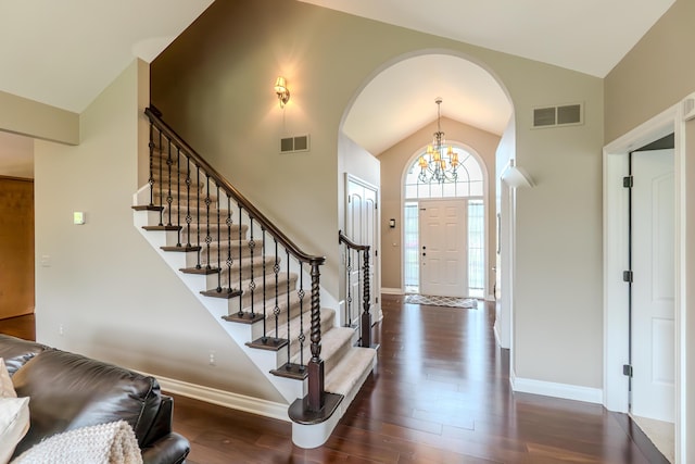 133 E Auburn Trl, Brighton, MI 48114 - entryway with dark wood-style floors, arched walkways, stairway, and high vaulted ceiling
