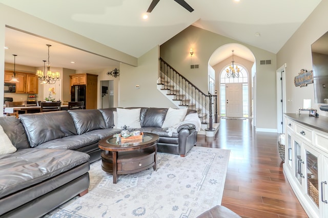 133 E Auburn Trl, Brighton, MI 48114 - living room with a chandelier, lofted ceiling, wood finished floors, stairs, and ceiling fan