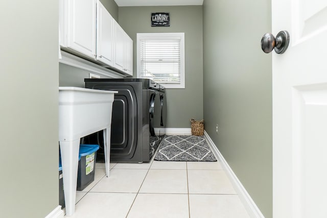 133 E Auburn Trl, Brighton, MI 48114 - laundry room with cabinet space, washing machine and clothes dryer, light tile patterned flooring, and baseboards