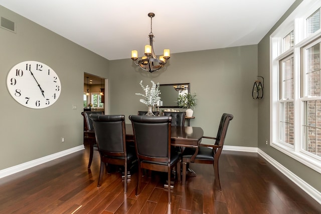 133 E Auburn Trl, Brighton, MI 48114 - dining area featuring a chandelier, wood finished floors, plenty of natural light, and baseboards