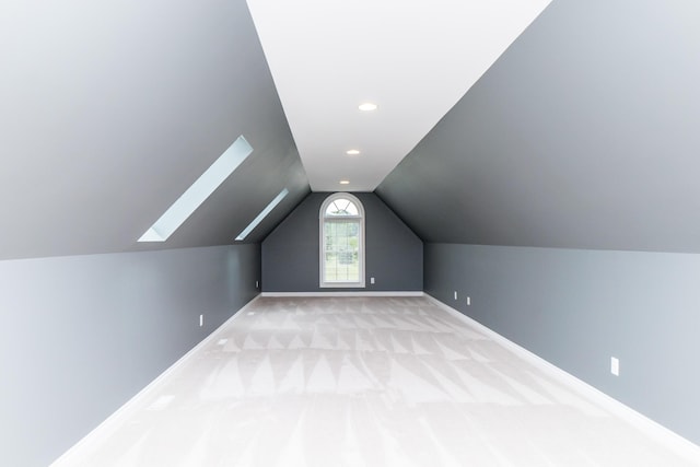 133 E Auburn Trl, Brighton, MI 48114 - additional living space with lofted ceiling, a skylight, baseboards, light carpet, and recessed lighting