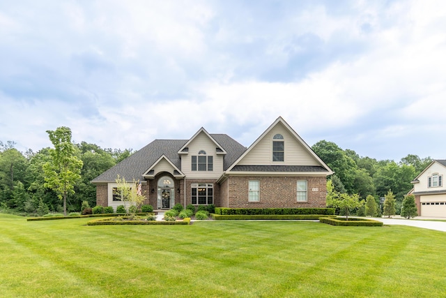 133 E Auburn Trl, Brighton, MI 48114 - view of front of home with brick siding, a front lawn, and a shingled roof