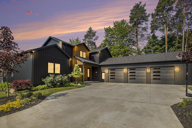 6646 E Eagle Lake Dr, Kalamazoo, MI 49009 - view of front of property with board and batten siding, an attached garage, driveway, and a shingled roof