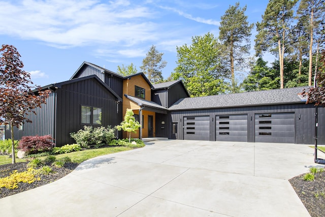 6646 E Eagle Lake Dr, Kalamazoo, MI 49009 - contemporary home featuring board and batten siding, concrete driveway, and a garage