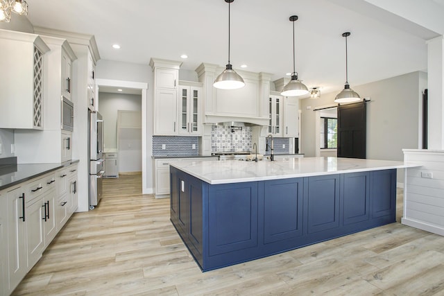 6646 E Eagle Lake Dr, Kalamazoo, MI 49009 - kitchen with light wood-type flooring, backsplash, stainless steel appliances, white cabinets, and glass insert cabinets
