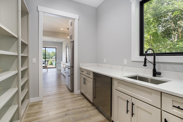 6646 E Eagle Lake Dr, Kalamazoo, MI 49009 - kitchen featuring a sink, stainless steel appliances, light wood finished floors, light stone countertops, and recessed lighting