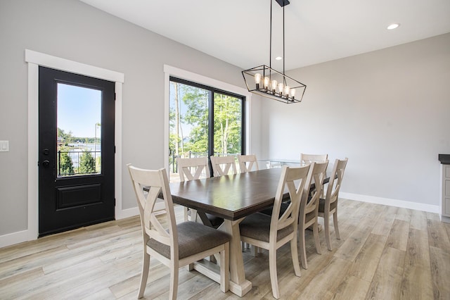 6646 E Eagle Lake Dr, Kalamazoo, MI 49009 - dining area with light wood-type flooring, a chandelier, baseboards, and recessed lighting