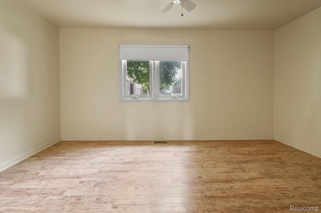 13716 Maple Grove Ave, Shelby Twp, MI 48315 - spare room featuring a ceiling fan, wood finished floors, and baseboards