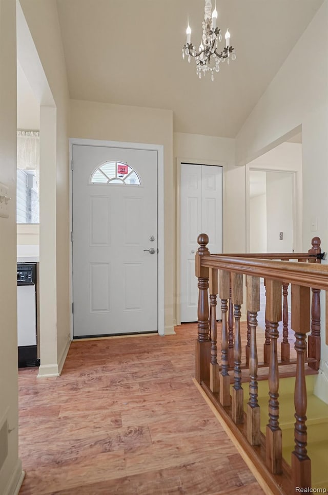 13716 Maple Grove Ave, Shelby Twp, MI 48315 - foyer entrance featuring a chandelier, light wood-style floors, lofted ceiling, healthy amount of natural light, and baseboards