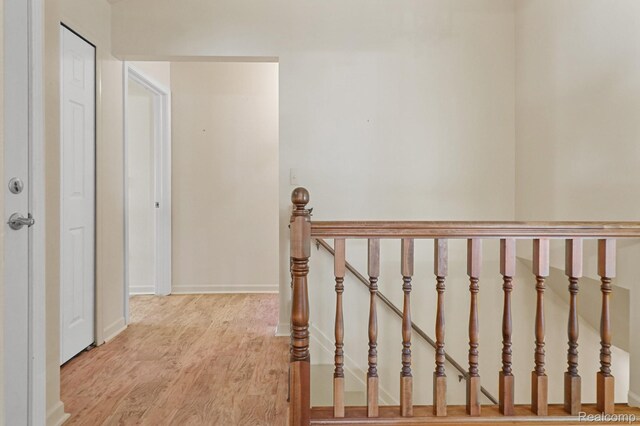 13716 Maple Grove Ave, Shelby Twp, MI 48315 - corridor with light wood-type flooring, an upstairs landing, and baseboards