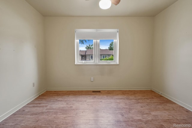 13716 Maple Grove Ave, Shelby Twp, MI 48315 - empty room with wood finished floors, ceiling fan, and baseboards