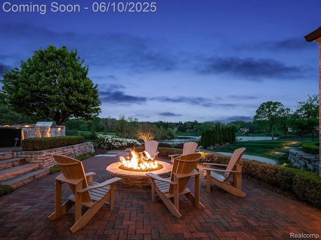 530 E Long Lake Rd, Bloomfield Hills, MI 48304 - patio terrace at dusk with an outdoor fire pit, a patio area, and area for grilling