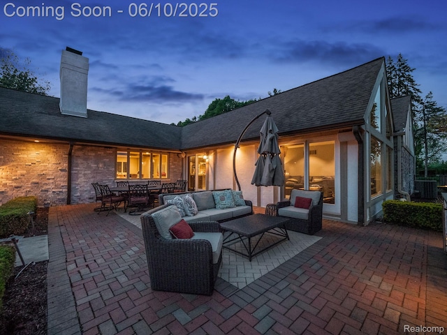 530 E Long Lake Rd, Bloomfield Hills, MI 48304 - patio terrace at dusk featuring a patio area, an outdoor hangout area, outdoor dining area, and central AC