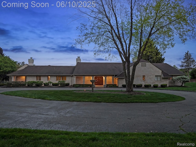 530 E Long Lake Rd, Bloomfield Hills, MI 48304 - view of front of property featuring curved driveway, a front lawn, and a chimney