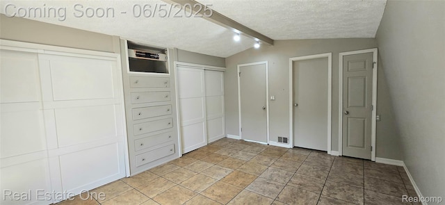 3825 Thomas Rd, Oxford, MI 48371 - unfurnished bedroom featuring a textured ceiling, baseboards, and multiple closets