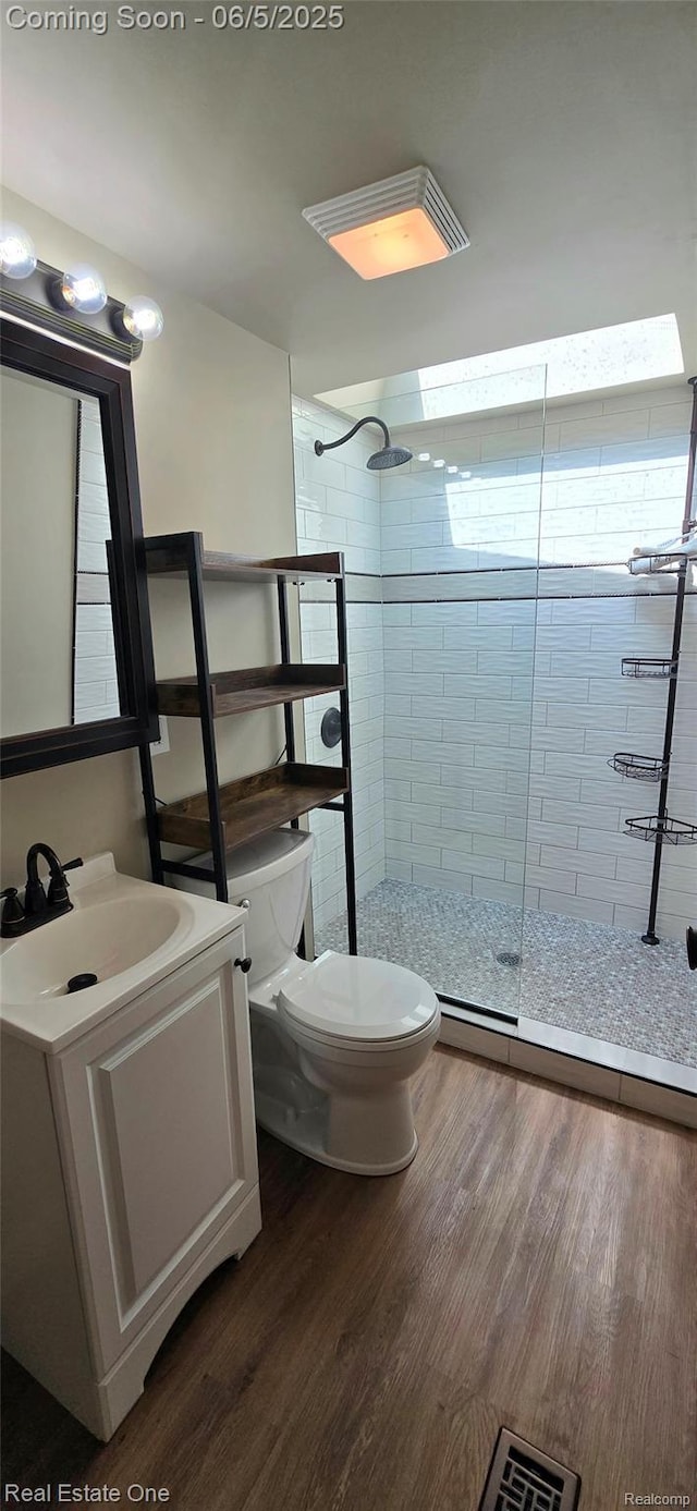 3825 Thomas Rd, Oxford, MI 48371 - bathroom with toilet, vanity, a shower stall, and wood finished floors