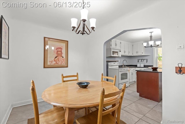14435 Prevost St, Redford, MI 48227 - dining space with a chandelier, arched walkways, and light tile patterned flooring