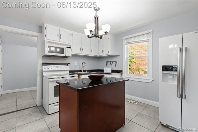 14435 Prevost St, Redford, MI 48227 - kitchen with white appliances, a chandelier, dark countertops, white cabinets, and light tile patterned floors