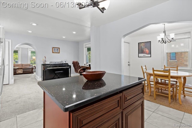 14435 Prevost St, Redford, MI 48227 - kitchen featuring arched walkways, light tile patterned flooring, a chandelier, recessed lighting, and light carpet