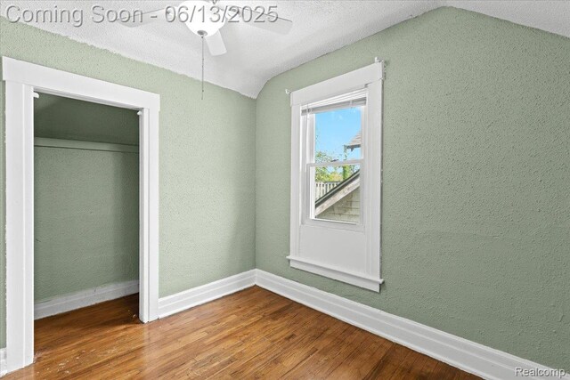 14435 Prevost St, Redford, MI 48227 - unfurnished bedroom featuring vaulted ceiling, wood finished floors, a closet, a ceiling fan, and a textured wall