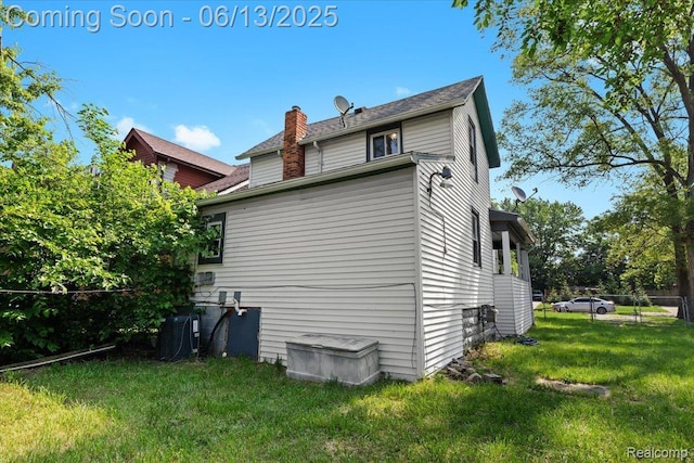 14435 Prevost St, Redford, MI 48227 - view of side of home featuring a central air condition unit and a chimney