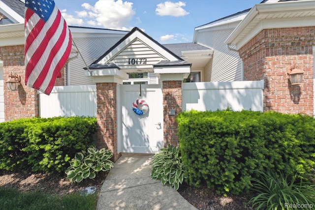 10172 Clarkshire Ct, South Lyon, MI 48178 - doorway to property with brick siding