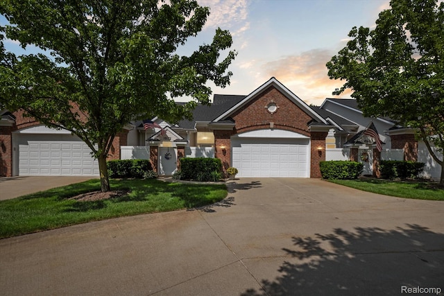 10172 Clarkshire Ct, South Lyon, MI 48178 - traditional home with brick siding, concrete driveway, a garage, and a front yard