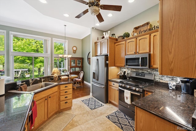 10172 Clarkshire Ct, South Lyon, MI 48178 - kitchen with stainless steel appliances, backsplash, ceiling fan, a sink, and a chandelier