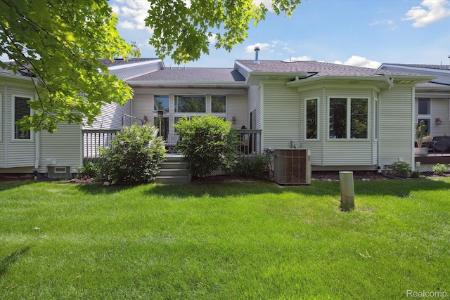 10172 Clarkshire Ct, South Lyon, MI 48178 - back of house with cooling unit, a deck, a lawn, and a shingled roof