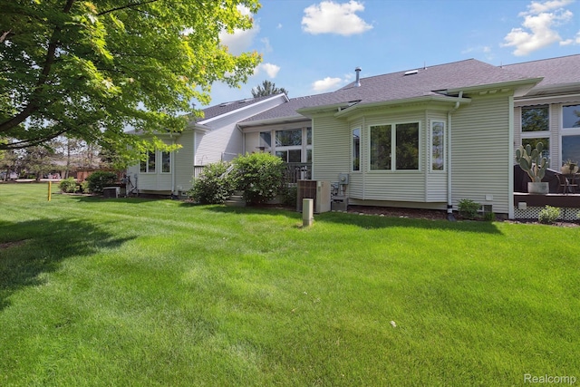 10172 Clarkshire Ct, South Lyon, MI 48178 - back of house with a yard, a shingled roof, and cooling unit
