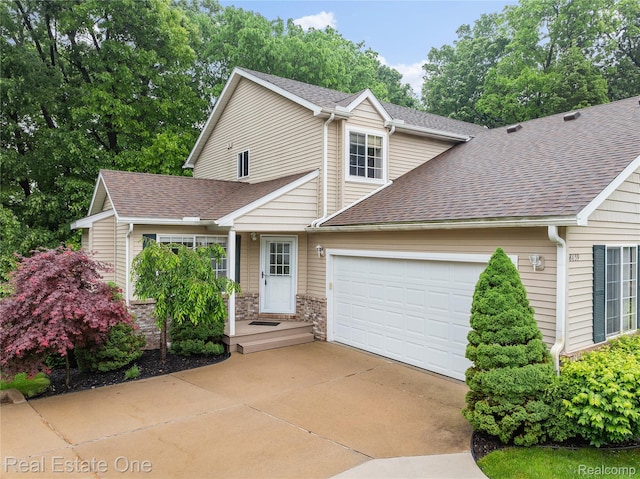 8859 Redstone Dr, Pinckney, MI 48169 - traditional-style house featuring a shingled roof, an attached garage, and driveway