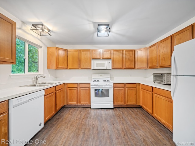 8859 Redstone Dr, Pinckney, MI 48169 - kitchen with white appliances, a sink, dark wood finished floors, and light countertops