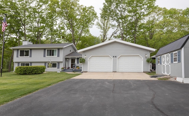 66 Meridian Ct, Mount Pleasant, MI 48858 - tri-level home with an outdoor structure, a chimney, and a front lawn