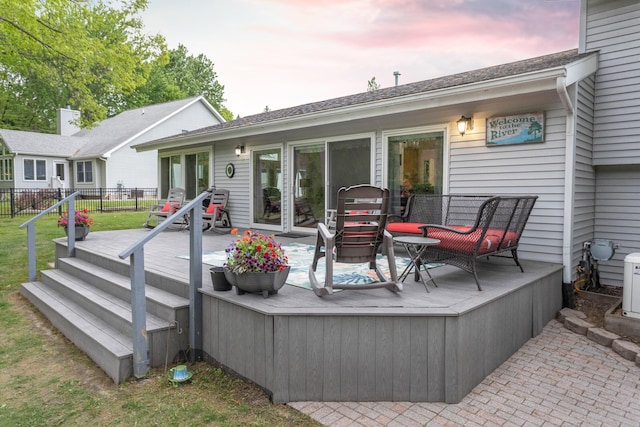 66 Meridian Ct, Mount Pleasant, MI 48858 - back of property at dusk with a wooden deck