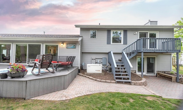 66 Meridian Ct, Mount Pleasant, MI 48858 - back of house with a patio area, stairs, a chimney, and a deck