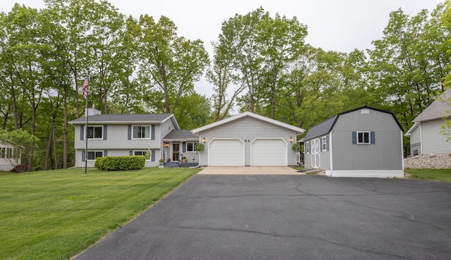 66 Meridian Ct, Mount Pleasant, MI 48858 - view of front of property with driveway, a garage, a front yard, and a chimney