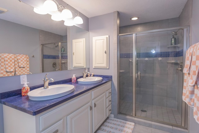 66 Meridian Ct, Mount Pleasant, MI 48858 - full bathroom featuring double vanity, a stall shower, and tile patterned flooring