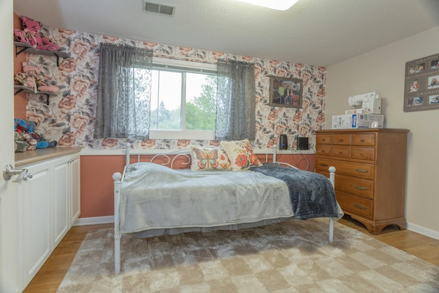 66 Meridian Ct, Mount Pleasant, MI 48858 - bedroom with light wood-style flooring, baseboards, and wallpapered walls