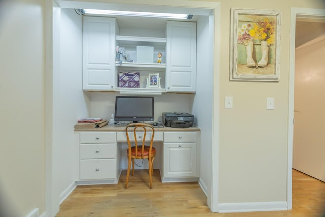 66 Meridian Ct, Mount Pleasant, MI 48858 - home office featuring built in desk, light wood finished floors, and baseboards