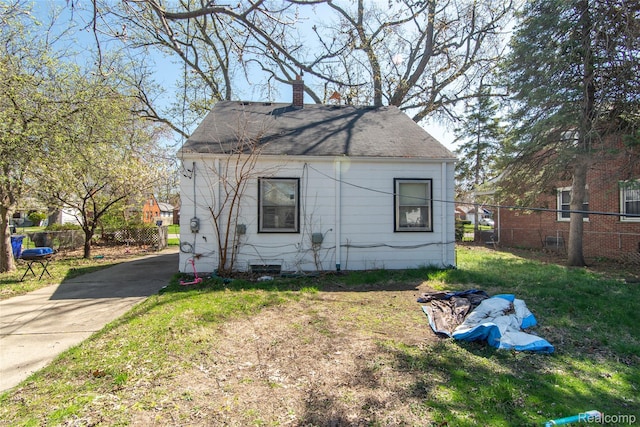 19683 Sunset St, Detroit, MI 48234 - view of front of house featuring a chimney and roof with shingles