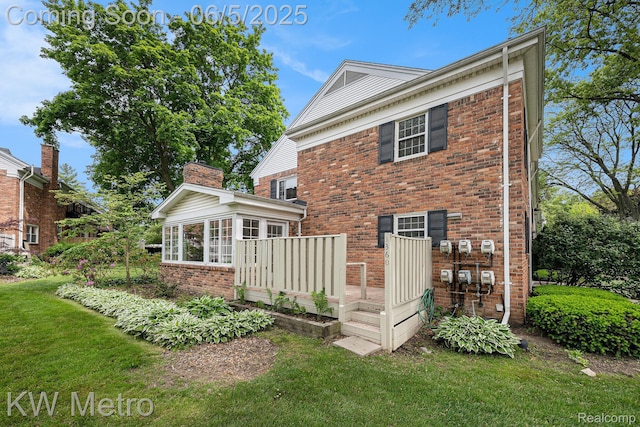 1360 Trailwood Path, Bloomfield Hills, MI 48301 - rear view of house featuring brick siding, a lawn, a wooden deck, and a sunroom