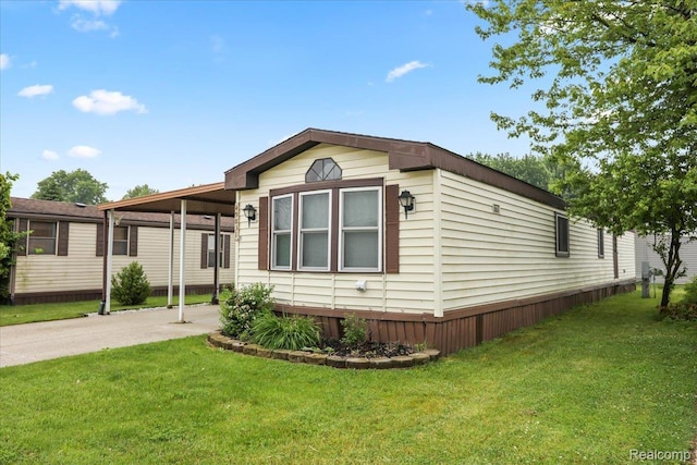 49831 Leicester Ct, Shelby Twp, MI 48315 - manufactured / mobile home with a carport, a front lawn, and driveway