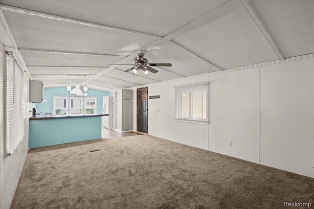 49831 Leicester Ct, Shelby Twp, MI 48315 - unfurnished living room with carpet flooring, vaulted ceiling, ceiling fan, and a chandelier