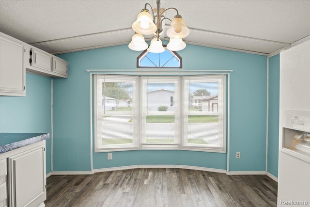 49831 Leicester Ct, Shelby Twp, MI 48315 - unfurnished dining area featuring a chandelier, vaulted ceiling, dark wood-style flooring, baseboards, and a textured ceiling