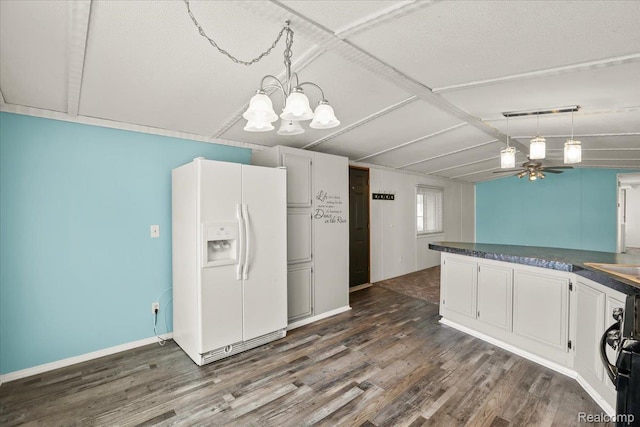 49831 Leicester Ct, Shelby Twp, MI 48315 - kitchen with white fridge with ice dispenser, dark wood-style floors, dark countertops, pendant lighting, and vaulted ceiling