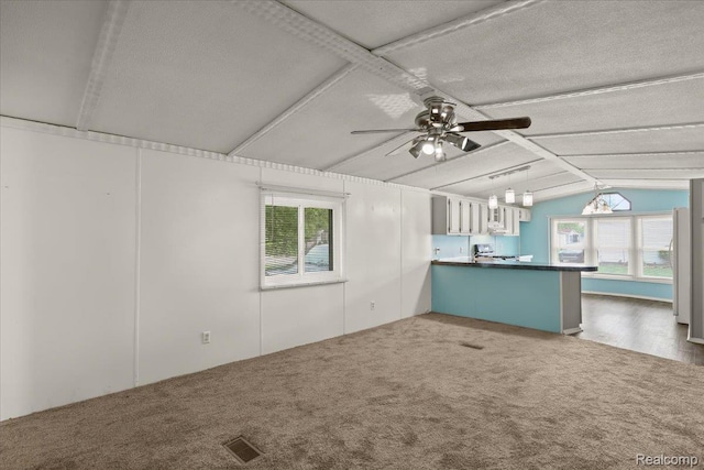 49831 Leicester Ct, Shelby Twp, MI 48315 - unfurnished living room featuring a ceiling fan, carpet, and a textured ceiling