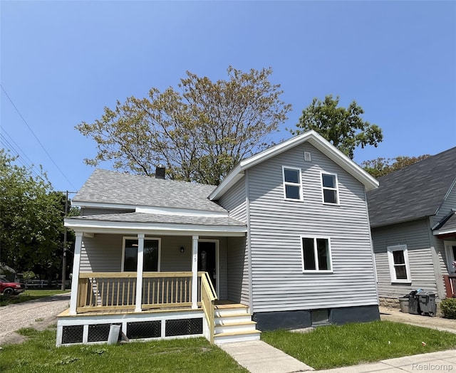 1015 9th St, Port Huron, MI 48060 - view of front of house with a porch and a shingled roof